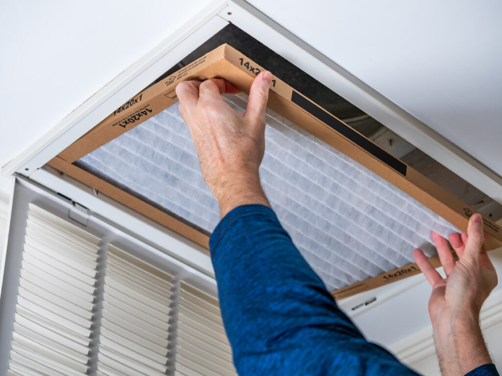 HVAC technician replacing a home air filter in Burbank