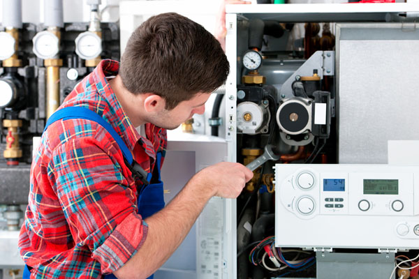 Heating technician repairing boiler controls in Burbank