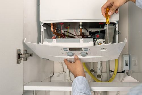 Heating technician repairing a residential boiler in Burbank