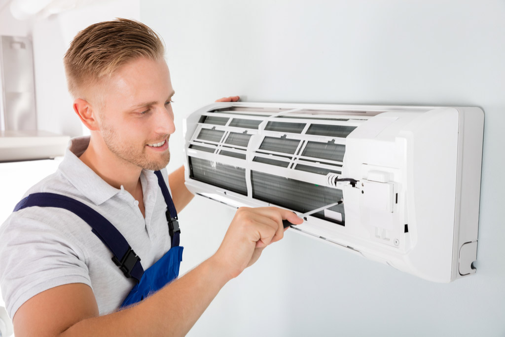 HVAC technician maintaining a ductless air conditioner in Burbank