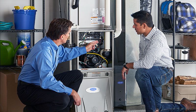Technician evaluating a furnace for repair or replacement in Burbank