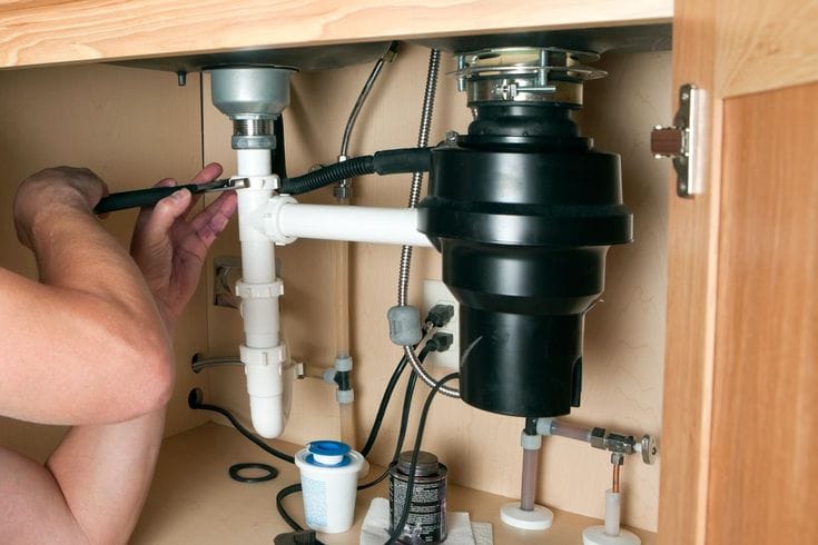 Plumber repairing a garbage disposal in Burbank
