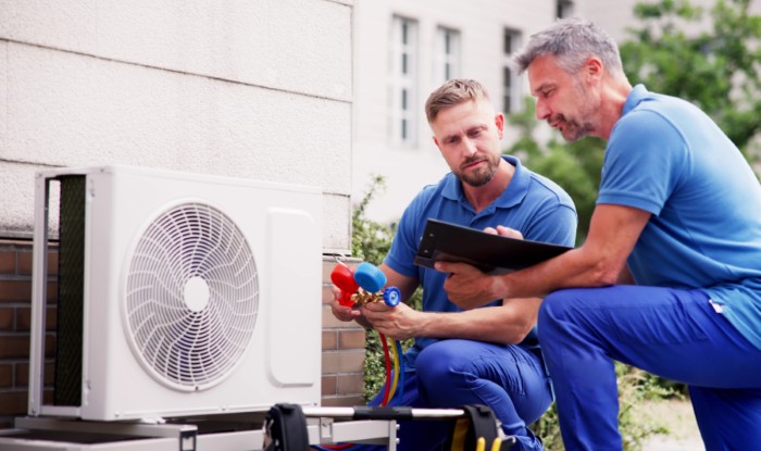 HVAC technicians installing an outdoor air conditioning unit in Burbank