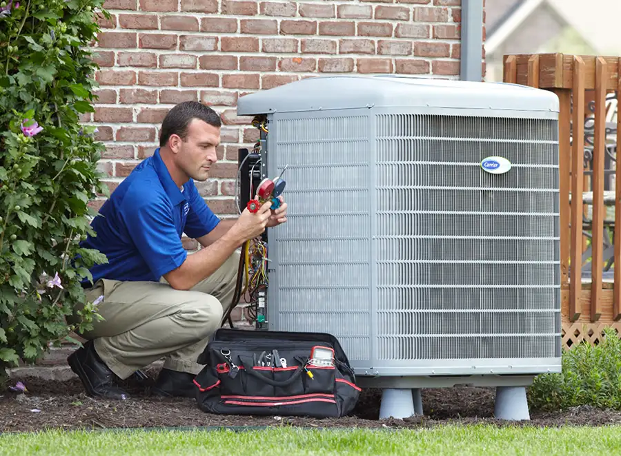 HVAC technician inspecting an outdoor AC unit in Burbank